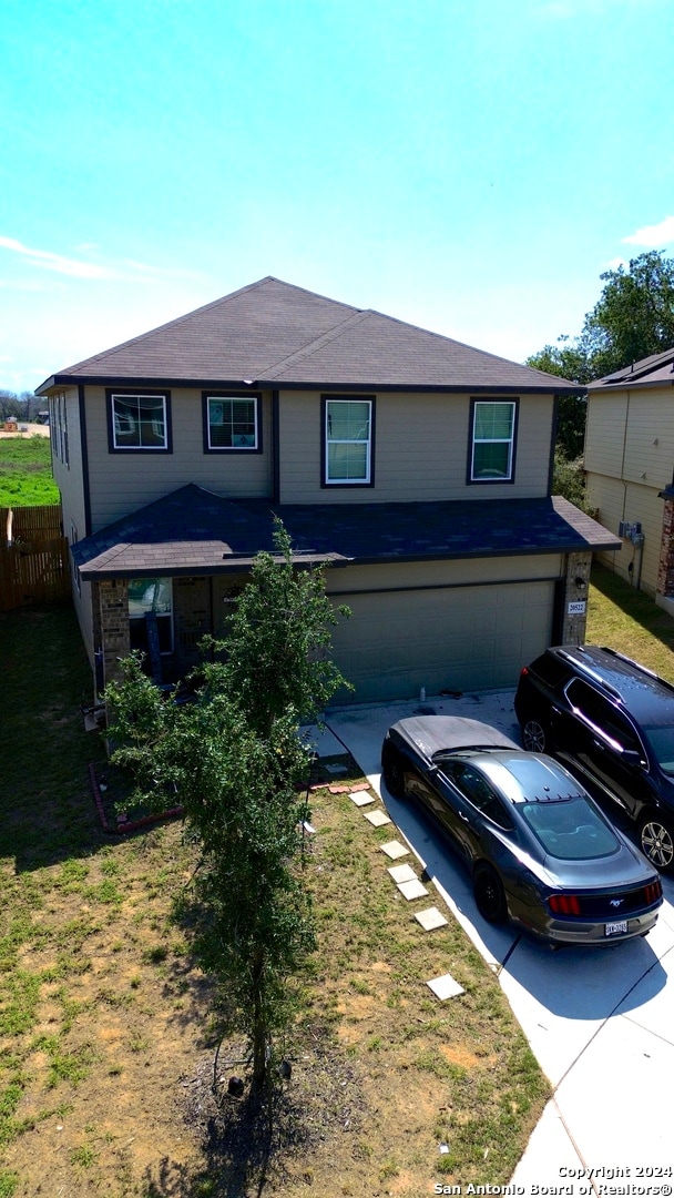 view of front of home featuring a garage and a front lawn