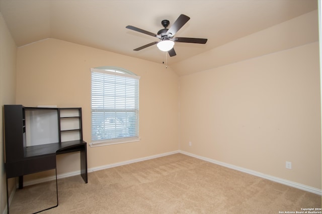 interior space featuring ceiling fan, lofted ceiling, and light carpet