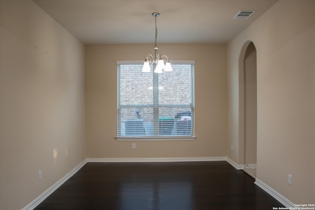 interior space with plenty of natural light, dark hardwood / wood-style flooring, and a chandelier