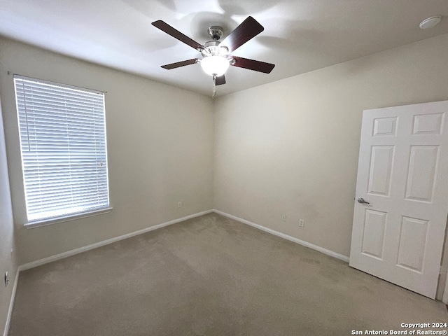 spare room featuring ceiling fan and carpet floors