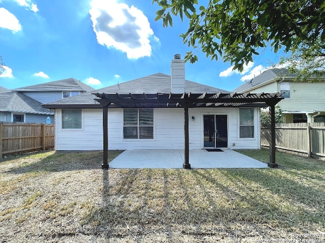 rear view of property featuring a pergola, a yard, and a patio area