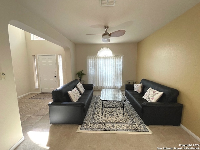 living room with ceiling fan, light colored carpet, and a wealth of natural light