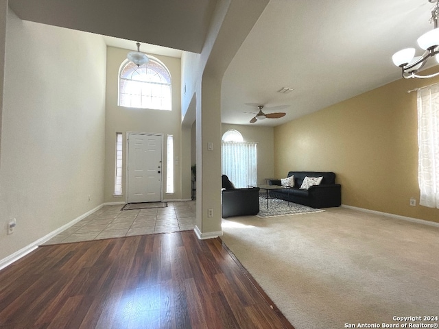 entrance foyer with wood-type flooring and ceiling fan with notable chandelier