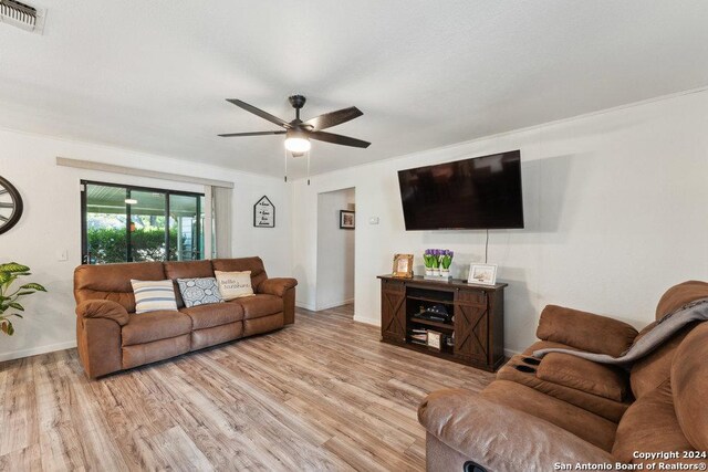 living room featuring light hardwood / wood-style floors and ceiling fan