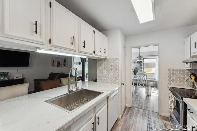 kitchen featuring white dishwasher, stainless steel electric range, white cabinetry, and sink