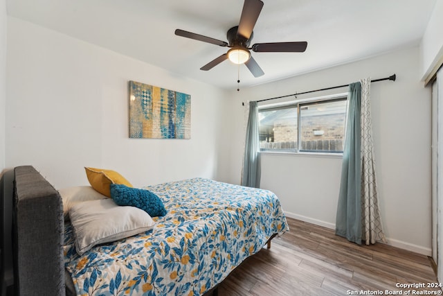 bedroom with wood-type flooring and ceiling fan