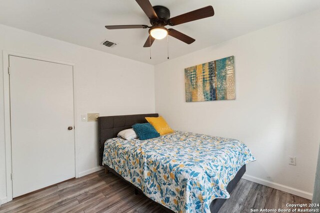 bedroom with ceiling fan and hardwood / wood-style flooring