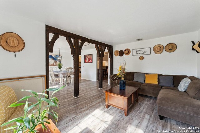 living room with wood-type flooring and a chandelier