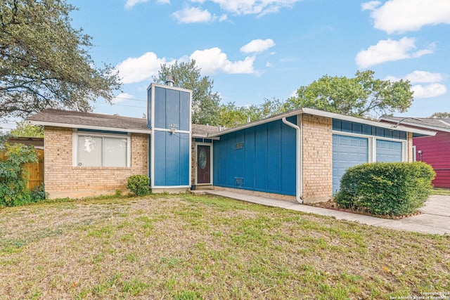 view of front of home with a garage and a front lawn