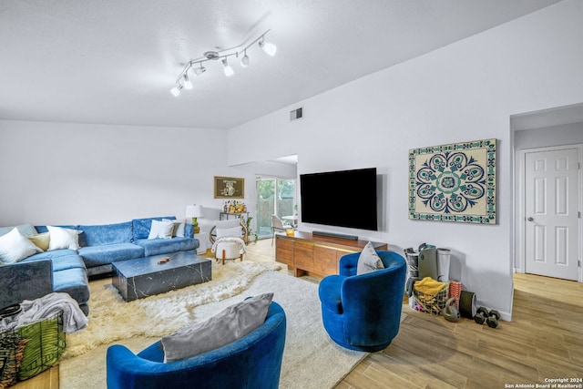 living room with lofted ceiling and hardwood / wood-style flooring