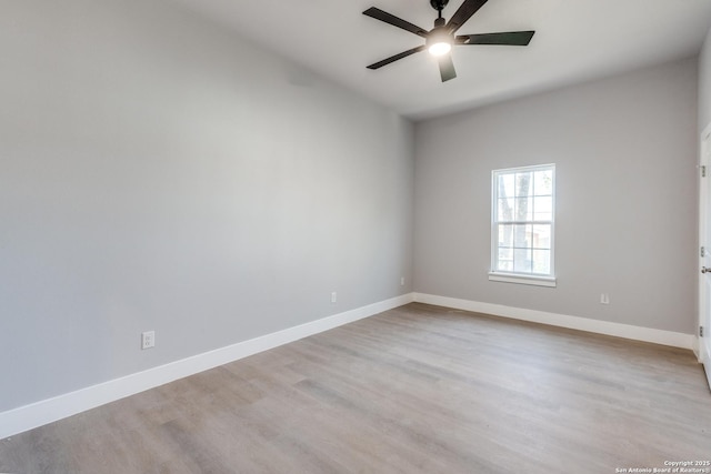 empty room with ceiling fan and light hardwood / wood-style floors