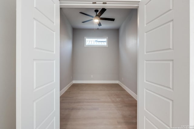 empty room with ceiling fan and light hardwood / wood-style flooring