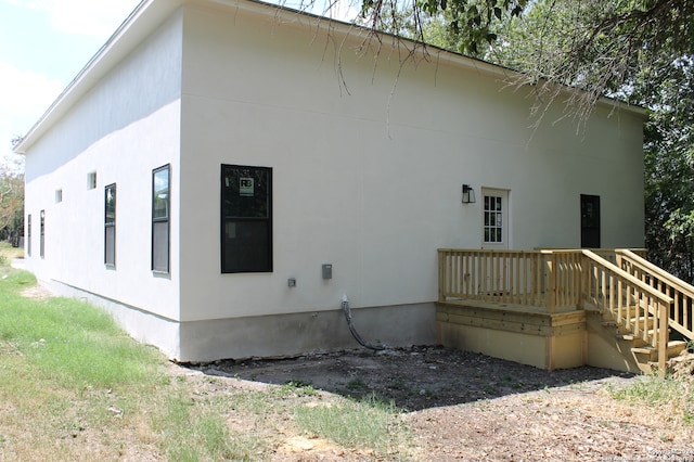 rear view of house featuring a wooden deck