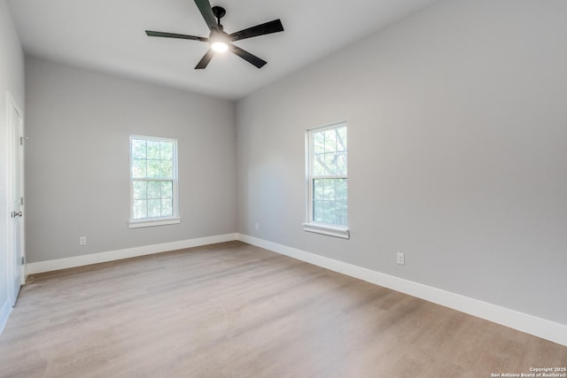 empty room with ceiling fan and light hardwood / wood-style floors