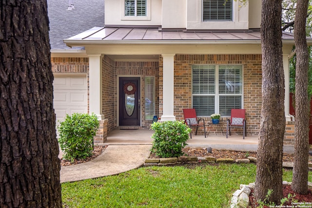 entrance to property with a garage and a porch