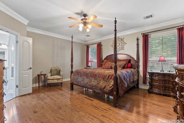 bedroom featuring light wood-type flooring, ceiling fan, and crown molding