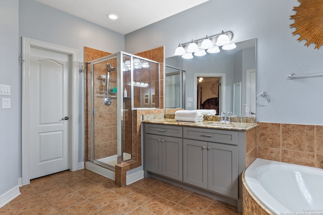 bathroom with shower with separate bathtub, tile patterned flooring, and vanity