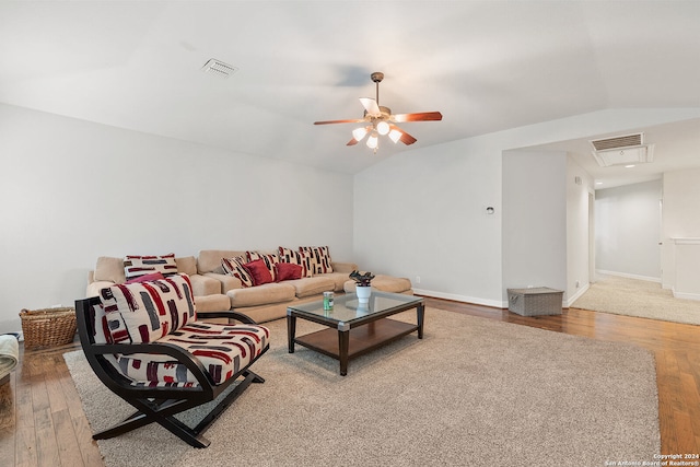 living room with wood-type flooring, vaulted ceiling, and ceiling fan