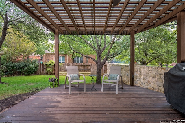 deck featuring a pergola, area for grilling, and a yard