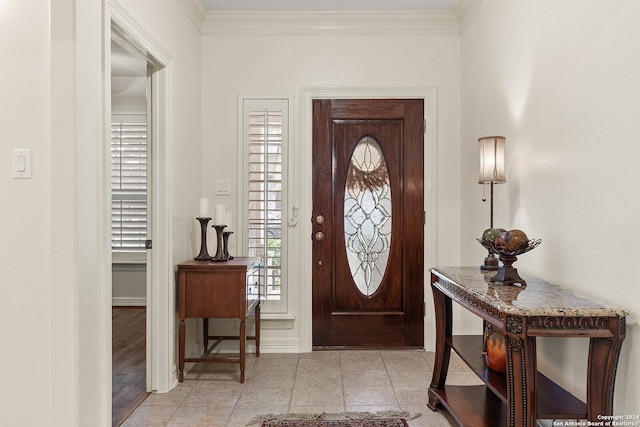 entrance foyer with crown molding and light hardwood / wood-style floors