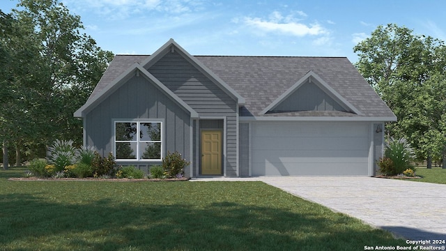 view of front of property with a garage and a front lawn