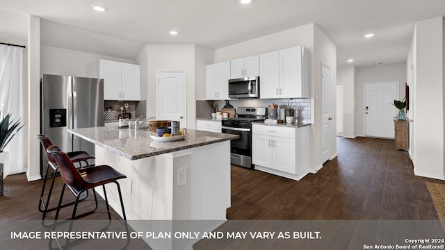 kitchen with a center island with sink, white cabinetry, dark hardwood / wood-style flooring, and stainless steel appliances