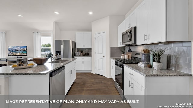 kitchen featuring white cabinets, sink, a center island with sink, stainless steel appliances, and dark hardwood / wood-style floors