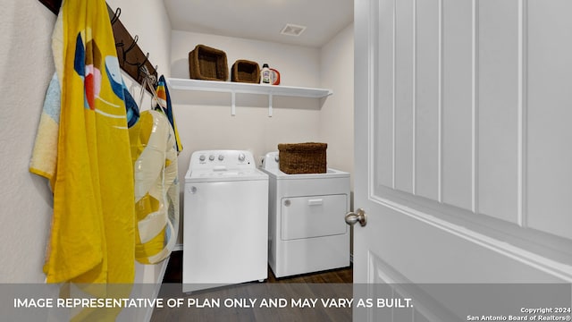 washroom with separate washer and dryer and dark wood-type flooring