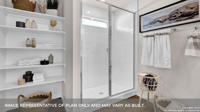 bathroom featuring hardwood / wood-style flooring and an enclosed shower