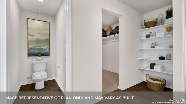 bathroom with hardwood / wood-style floors and toilet