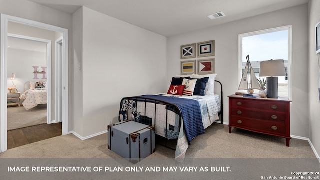 bedroom with multiple windows and light colored carpet