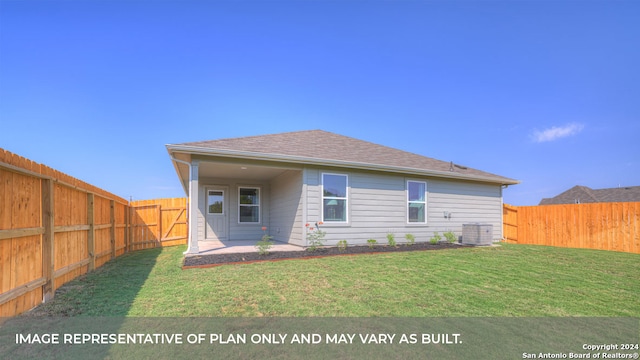 back of property with cooling unit and a yard