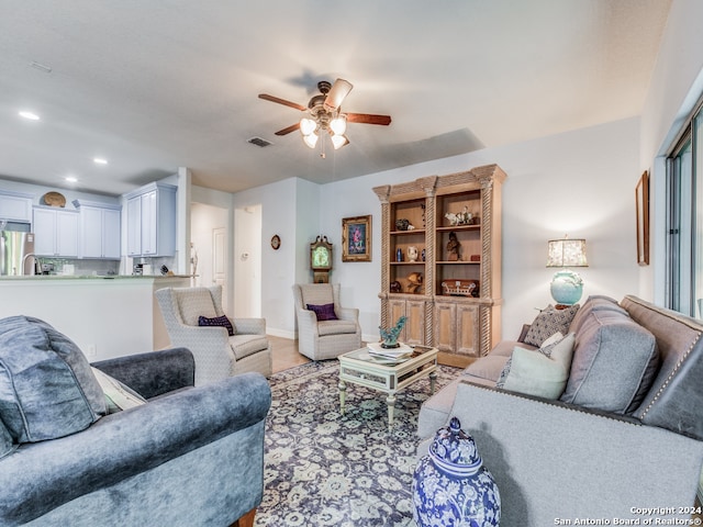 living room featuring ceiling fan and hardwood / wood-style floors