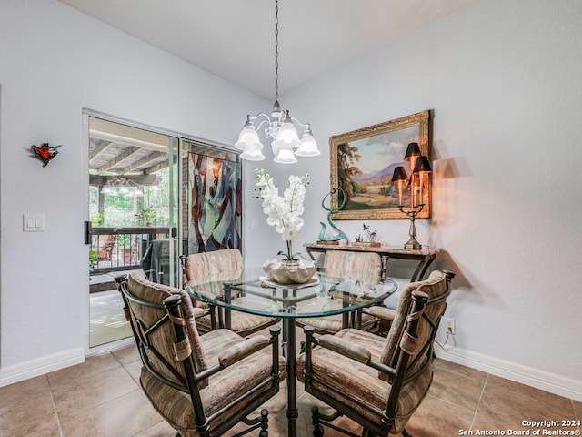 tiled dining area with a chandelier