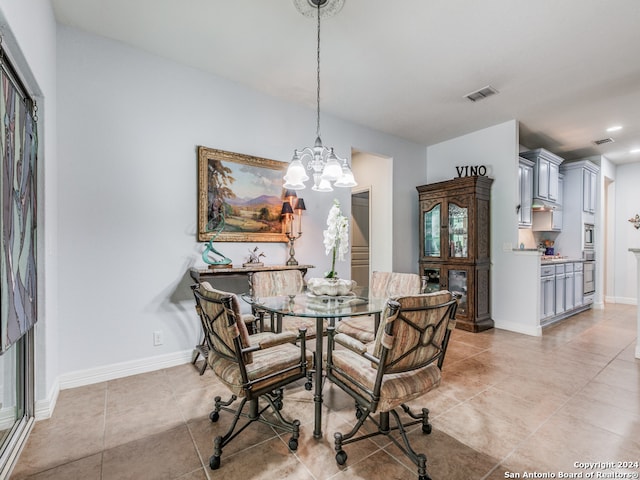 dining room with a chandelier and light tile patterned floors