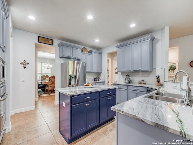 kitchen with stainless steel fridge with ice dispenser, sink, backsplash, light tile patterned floors, and light stone countertops