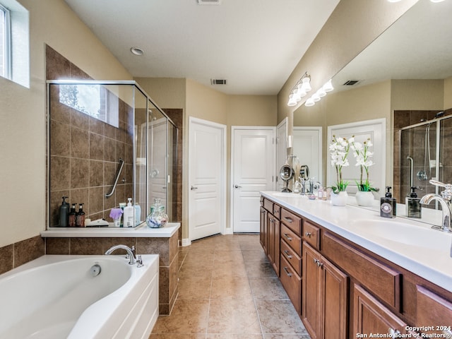 bathroom featuring independent shower and bath, vanity, tile patterned floors, and a healthy amount of sunlight