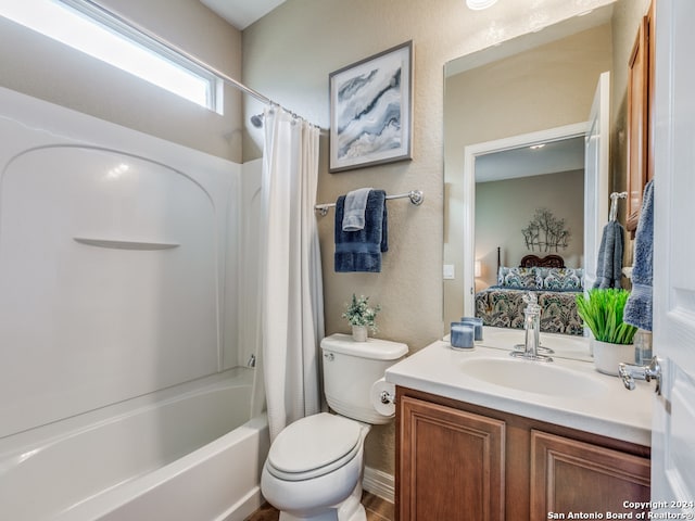 full bathroom featuring vanity, shower / bath combo with shower curtain, and toilet