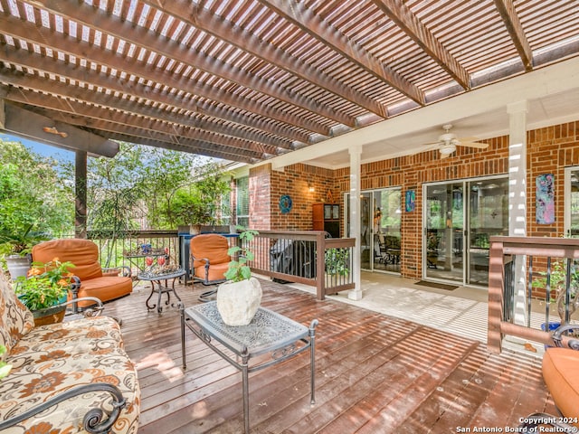 wooden deck with ceiling fan and a pergola