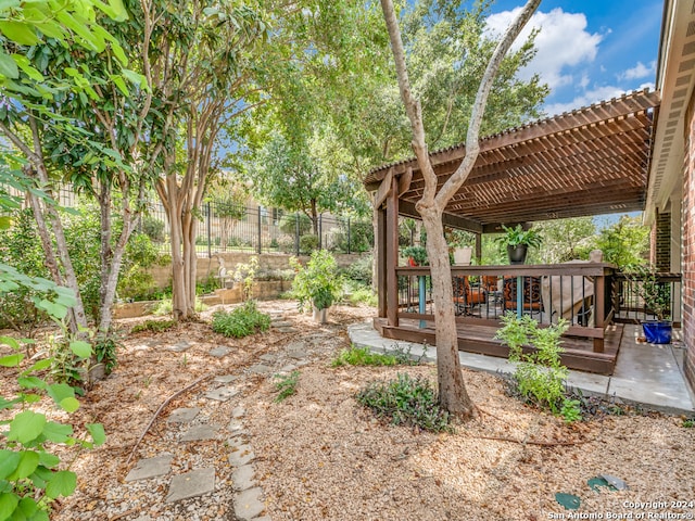 view of yard featuring a deck and a pergola