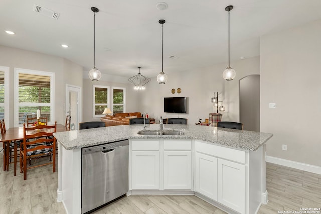 kitchen with light hardwood / wood-style flooring, white cabinets, plenty of natural light, and stainless steel dishwasher