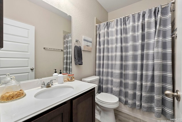 bathroom featuring curtained shower, vanity, toilet, and hardwood / wood-style flooring