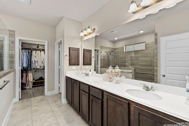 bathroom with vanity, tile patterned floors, and a shower with shower door