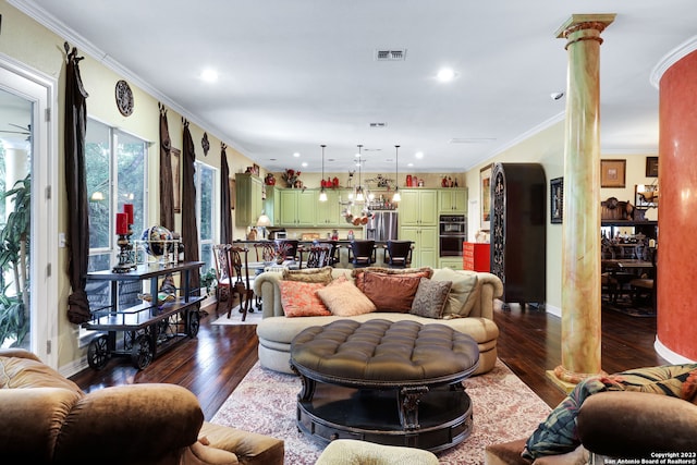 living room with crown molding, dark hardwood / wood-style floors, and ornate columns