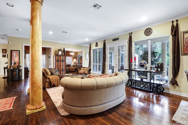 living room with decorative columns, ornamental molding, and dark wood-type flooring