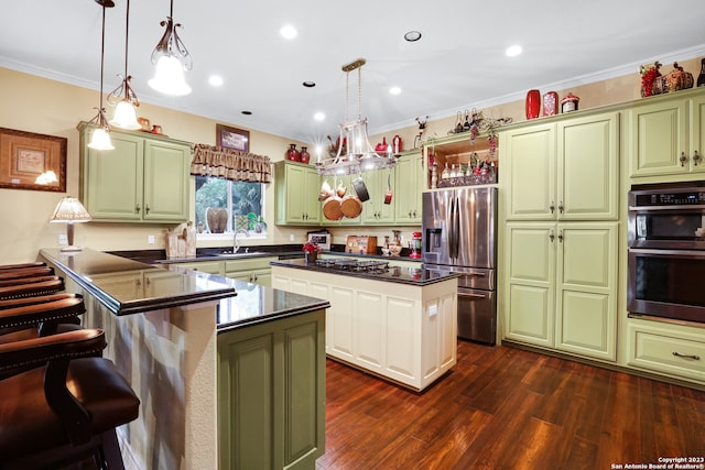 kitchen with decorative light fixtures, stainless steel appliances, a center island, crown molding, and dark hardwood / wood-style flooring