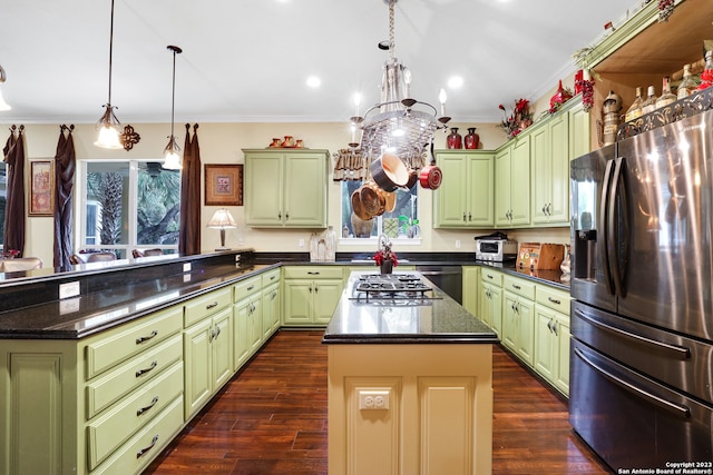 kitchen featuring a kitchen island, dark hardwood / wood-style flooring, green cabinets, and stainless steel appliances