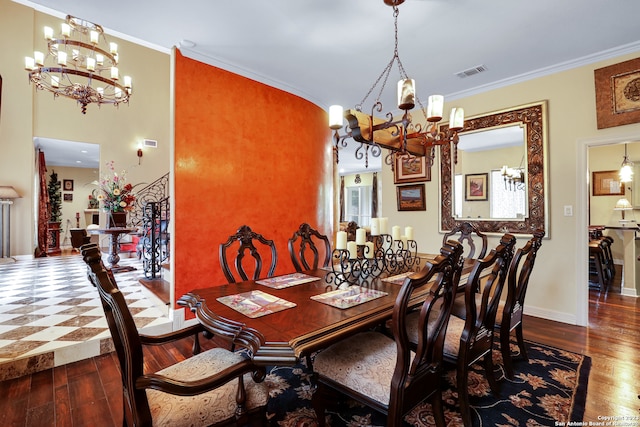 dining space featuring crown molding, hardwood / wood-style floors, and a notable chandelier