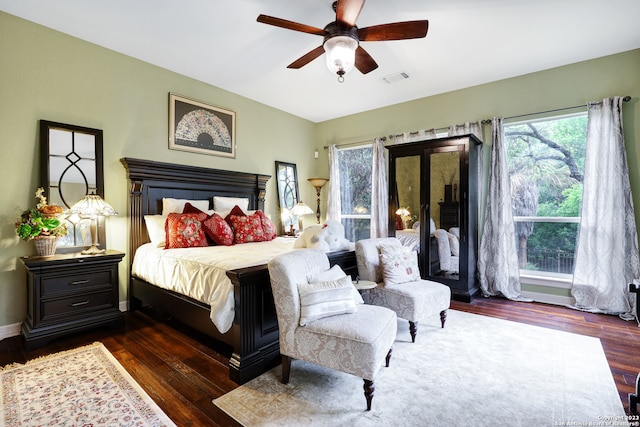 bedroom with ceiling fan and dark wood-type flooring