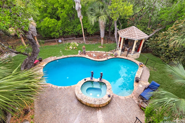 view of pool with a lawn, a gazebo, an in ground hot tub, and a patio area